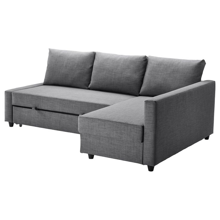 a gray couch sitting next to a white wall