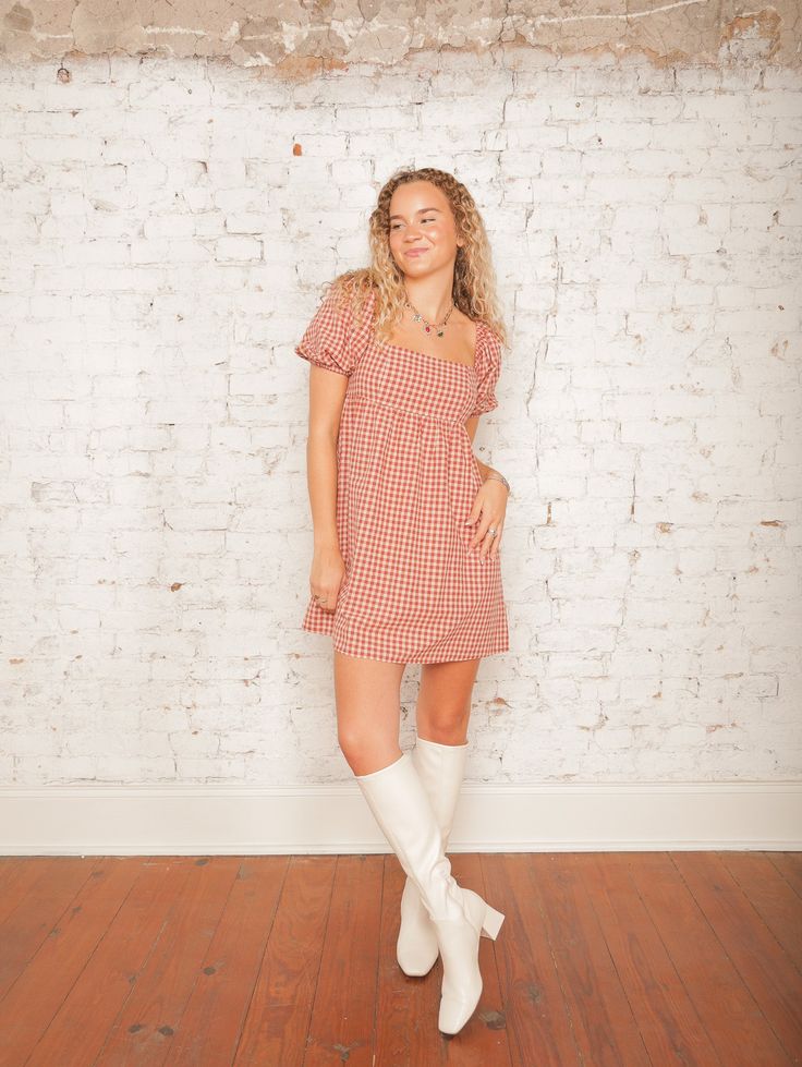 Our Nora Checkered Dress is a sweet babydoll style that brings a playful touch to any outfit with its rust checkered print and square neckline. The short elastic bubble sleeves add a charming detail, perfect for an outdoor fall wedding or event. Style it with ankle booties and a wide-brimmed hat for a cute, carefree look! Details Square Neck Short Elastic Bubble Sleeves Rust Checkered Print Hidden Back Zipper with Hook & Eye Closure Babydoll Style Mini Length Partially Lined Size recs: 2-4 Small, 4-6 Medium, 8-10 Large Provides no stretch Model is 5'8" wearing a size Small Cute Fitted Mini-length Plaid Dress, Cute Gingham Square Neck Dress, Fitted Gingham Mini Dress With Square Neck, Fall Plaid Dress With Square Neck, Casual Plaid Dress With Square Neck For Fall, Casual Square Neck Plaid Dress For Fall, Fitted Plaid Dress With Puff Sleeves For Casual Wear, Fitted Plaid Dress With Square Neck, Casual Fitted Plaid Dress With Puff Sleeves