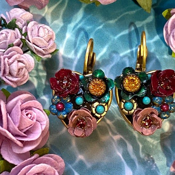 Lightweight, multicolor floral earrings, handmade with bright and glittering Swarovski crystals and enemel. This classic pair is sure to be a wardrobe staple that will brighten up any look.Item Details:-Materials: Swarovski crystals, glass beads, enamel-Metal: 24K gold electroplated over brass-Size: 1” long-Lever back-Handmade in our NYC studio-Complimentary gift wrapping -Item Number: S7618Repairs Policy:Repairs are free. Customers will only be asked to pay $5 for shipping.Expect processing tim Elegant Multicolor Earrings For Valentine's Day, Elegant Multicolor Heart Earrings For Gift, Elegant Multicolor Heart Earrings Gift, Multicolor Jeweled Clip-on Earrings As A Gift, Handmade Multicolor Earrings For Anniversary, Unique Gold Earrings For Valentine's Day, Nyc Studio, Cotton Crafts, Floral Heart