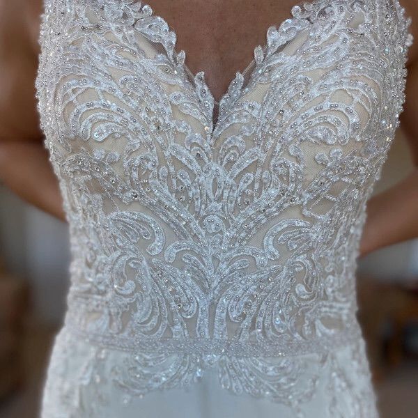 the back of a wedding dress with beading and sequins is seen in this close up photo