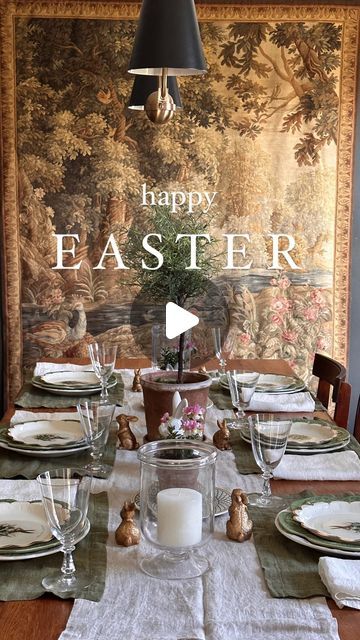 the table is set for easter dinner with an old tapestry in the backround