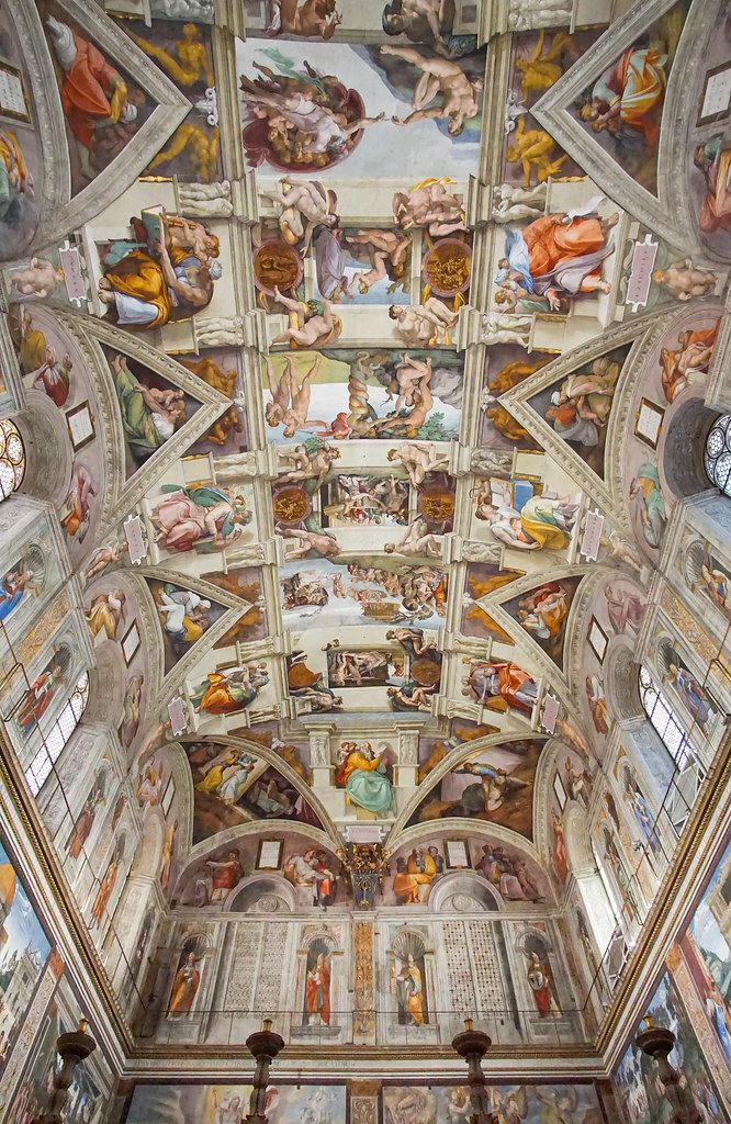 the ceiling is painted with many different paintings