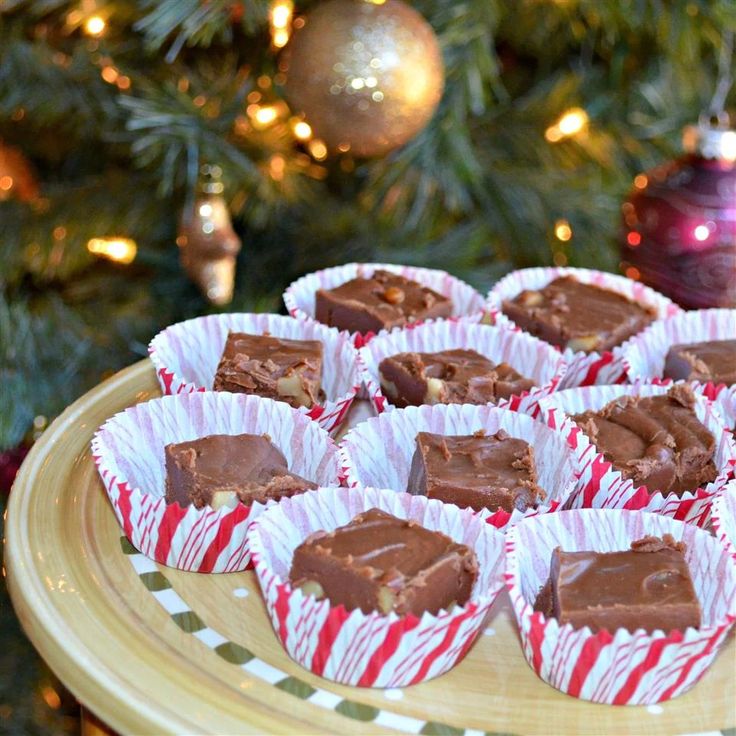 there are many pieces of chocolate in the paper cupcake wrappers on the table