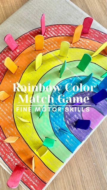 rainbow color match game for fine motor skills on a wooden table with text overlay reading rainbow color match game fine motor skills