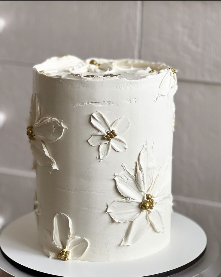 there is a white cake with flowers on it