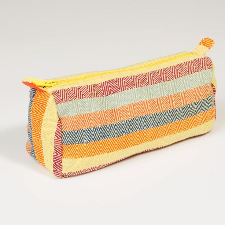 Handwoven in yellow diamond weave striped cotton in bright yellows, magenta, and orange, the convenient sized multipurpose cosmetics bag fits in your purse, tote bag, or suitcase. The waterproof lining protects everything else! Long handled zipper pull makes it easy to pull out what you need. 8”L x 3”W across the bottom x 4.5” D. Waterproof ripstop nylon lining in bright orange Long pull zipper Washable. Ethically made Magenta And Orange, Cotton Jewelry, Lime Yellow, Jewelry Roll, Diamond Weave, Cosmetics Bag, Toiletry Bags, Yellow Diamond, Crochet Crafts