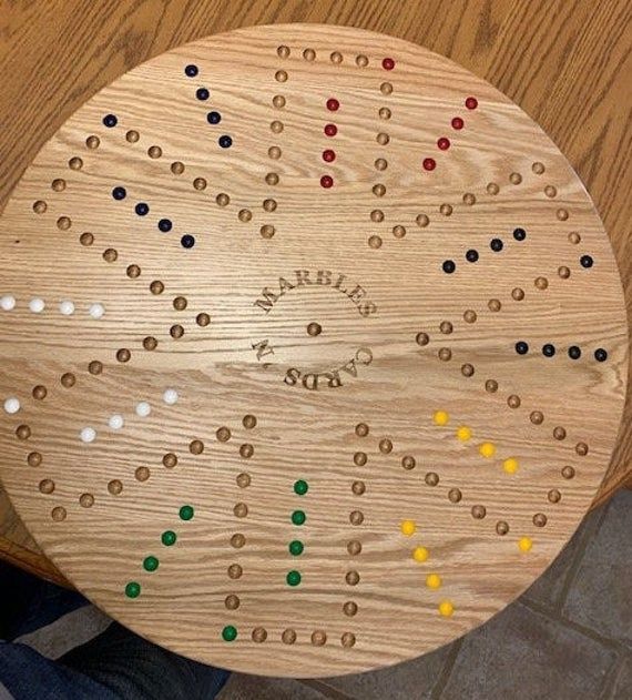 a wooden board game sitting on top of a table next to a pair of shoes