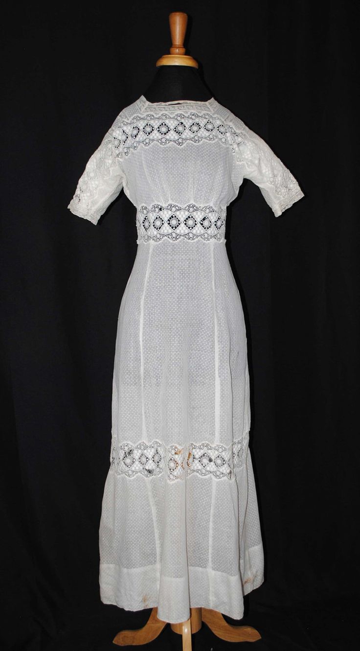 "EDWARDIAN FANCY TEA SUMMER DAY DRESS, 1910 Presenting a Edwardian snow white light weight sheer dotted swiss cotton summer tea day dress dating to the early 1900's to 1910. One piece in construction. This dress is for a tall woman. Short fitted sleeves with schiffli and valenciennes lace. The front bodice has a lovely wide white machine embroidered schiffli lace with open work motifs, with no collar. The bodice back has an extensive hook/eye closure extending into the skirt. Dress has no lining Fitted White Victorian Dress With Short Sleeves, Summer Victorian Dress With Empire Waist, Regency Style Prairie Dress For Summer Garden Party, Regency Style Summer Prairie Dress For Garden Party, White Fitted Victorian Dress For Garden Party, Summer Regency Prairie Dress For Garden Party, White Fitted Victorian Dress For Summer, White Fitted Victorian Summer Dress, Fitted White Prairie Dress With Short Sleeves