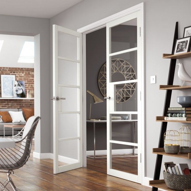 an open door leading to a living room with a dining table and chairs in it