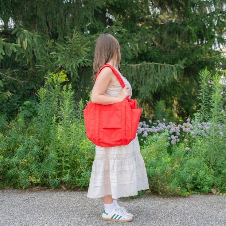 A travel bag optimized for flying: it fits under an airplane seat, on top of your roller bag, and on your shoulder. Exterior pockets keep your travel essentials within reach, including a tech pocket that fits up to a 16” laptop, and side pockets for your water bottle and boarding pass. The bag packs down into its interior detachable pouch for easy storage. If there's one thing we all agree on at Golden Rule, it's that Baggu is essential. Form and function meet in this eco carry-all that works ha Baggu Carry On, On-the-go Travel Backpack With Pockets, Versatile Gym Bag With Pockets For On-the-go, Backpack Travel Bag With Pockets For On-the-go, Nylon Bags With Multiple Pockets For Trip, Multifunctional Travel Bag With Multiple Pockets, Everyday Nylon Bags With Side Pockets, Casual Nylon Travel Bag For Weekend Trips, Functional Bags With Pockets For Trip