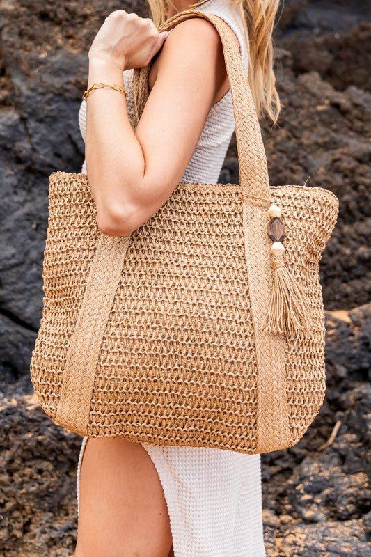 Izola Carry All Tassel Tote Global Village Kailua Boutique Affordable Trendy Straw Bag For Beach Season, Cheap Straw Tote Beach Bag, Cheap Bohemian Straw Bag With Large Capacity, Cheap Woven Beach Bag For Travel, Cheap Trendy Straw Tote Bag, Trendy Straw Tote Bag, Cheap Beige Straw Bag For Daily Use, Cheap Beachy Straw Bag For Everyday Use, Cheap Casual Straw Beach Bag