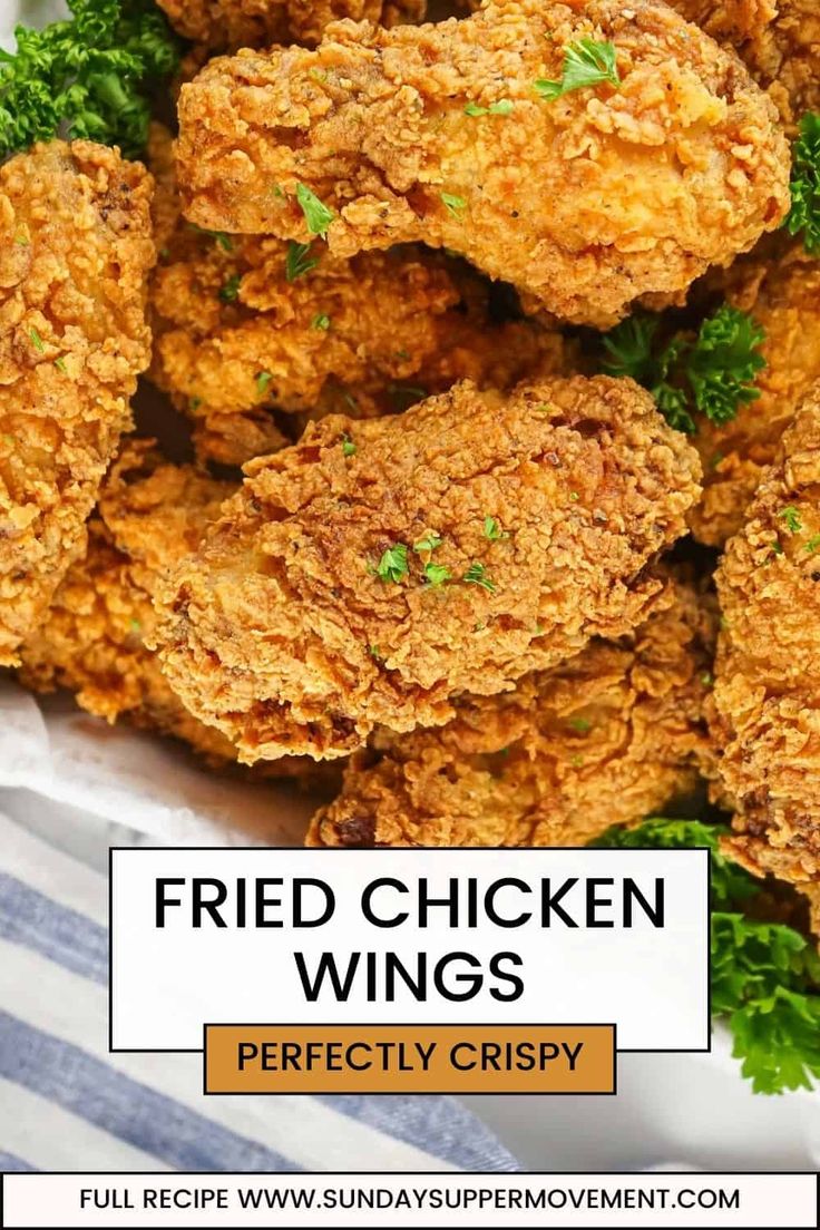 fried chicken wings in a basket with parsley on top and text overlay that reads fried chicken wings perfectly crispy