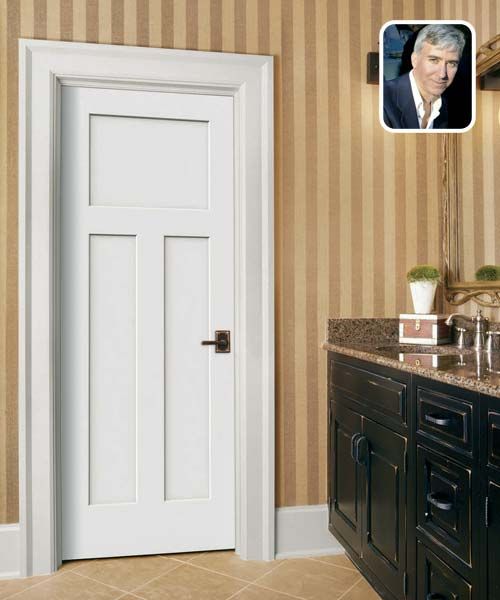 a white door in a bathroom next to a sink and vanity with a mirror on the wall