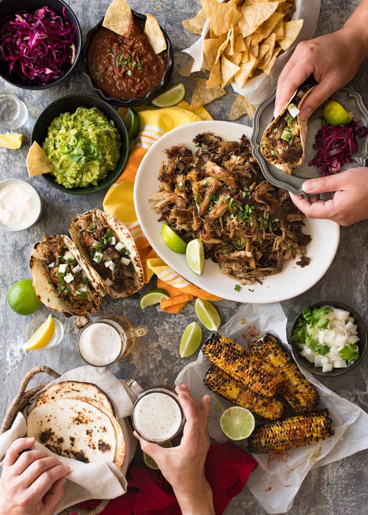 people are eating mexican food at a table