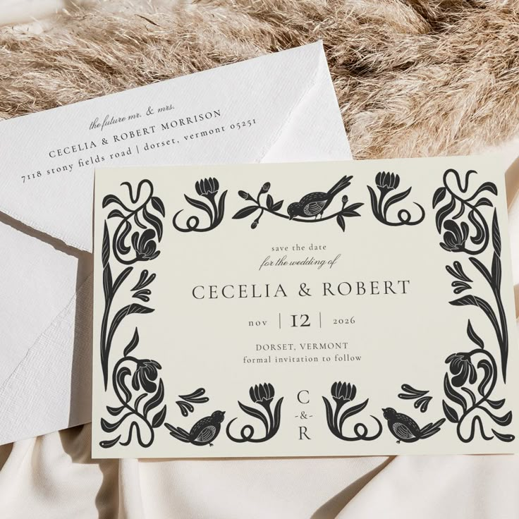 the wedding stationery is laid out on top of an unmade bed with fur