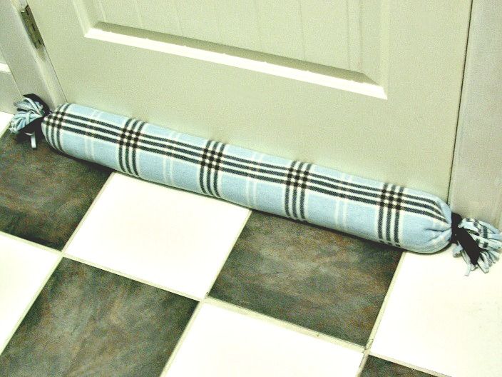 a black and white checkered bench cushion on the floor next to a door way