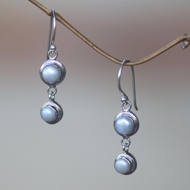 Silver moonlight radiates from luminous pearls, set in argent circles, they become dancing dangle earrings by Bali's Nyoman Rena. Pearls represent June´s birthstones. Sterling silver and freshwater cultured pearls Hook earrings Handmade in & fairly traded from Indonesia Pearl White Round Sterling Silver Pearl Earrings, Pearl White Sterling Silver Round Pearl Earrings, Silver Pearl Charm Earrings, Nickel-free Adjustable Round Pearl Earrings, Adjustable Round Pearl Earrings For Anniversary, Silver Earrings With Pearl Charm, Nickel-free Round Pearl Earrings For Anniversary, Nickel-free Pearl Earrings For Anniversary, Adjustable Silver Pearl Earrings For Anniversary