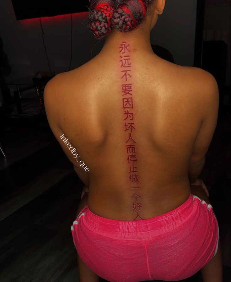 a woman with chinese writing on her back