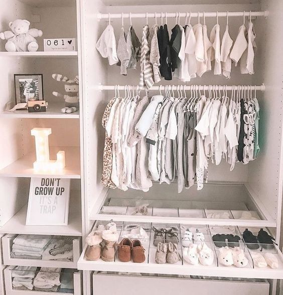 an open closet filled with baby clothes and shoes next to a sign that says pinterest