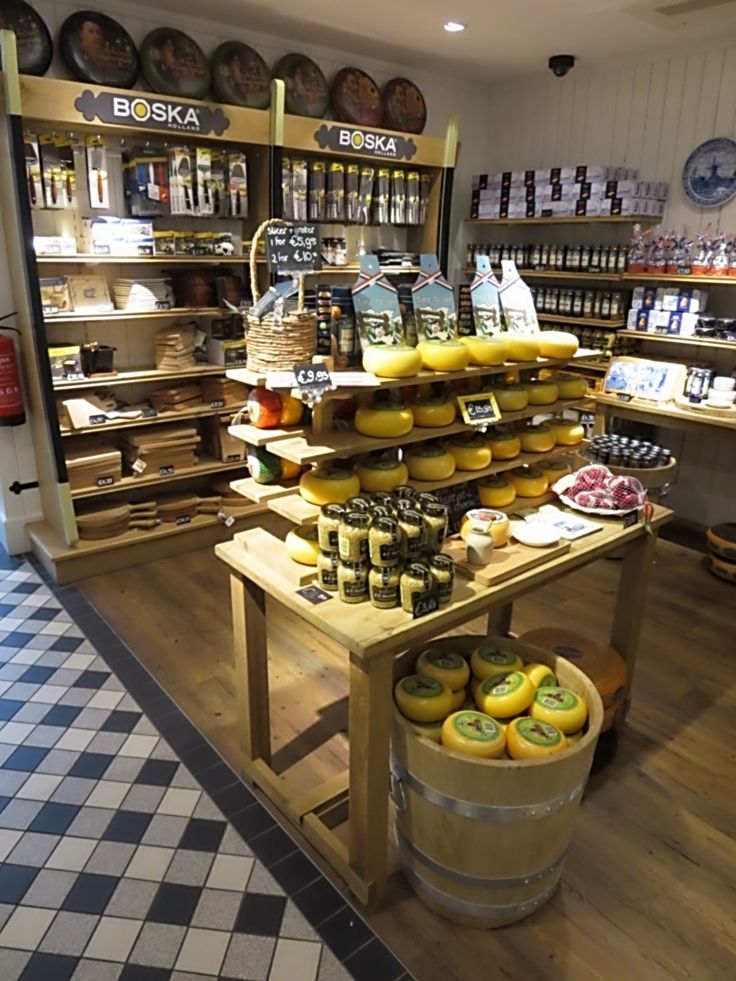 a store filled with lots of different types of cheeses and other foods on display