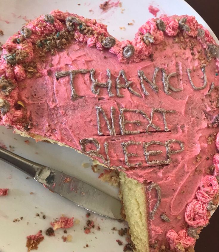 a heart shaped piece of cake with writing on it