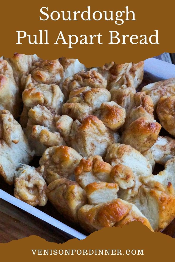 a close up of food in a pan with text overlay that reads sourdough pull apart bread