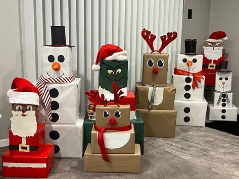 a group of cardboard boxes with santa claus and snowmen on them, all decorated in different colors