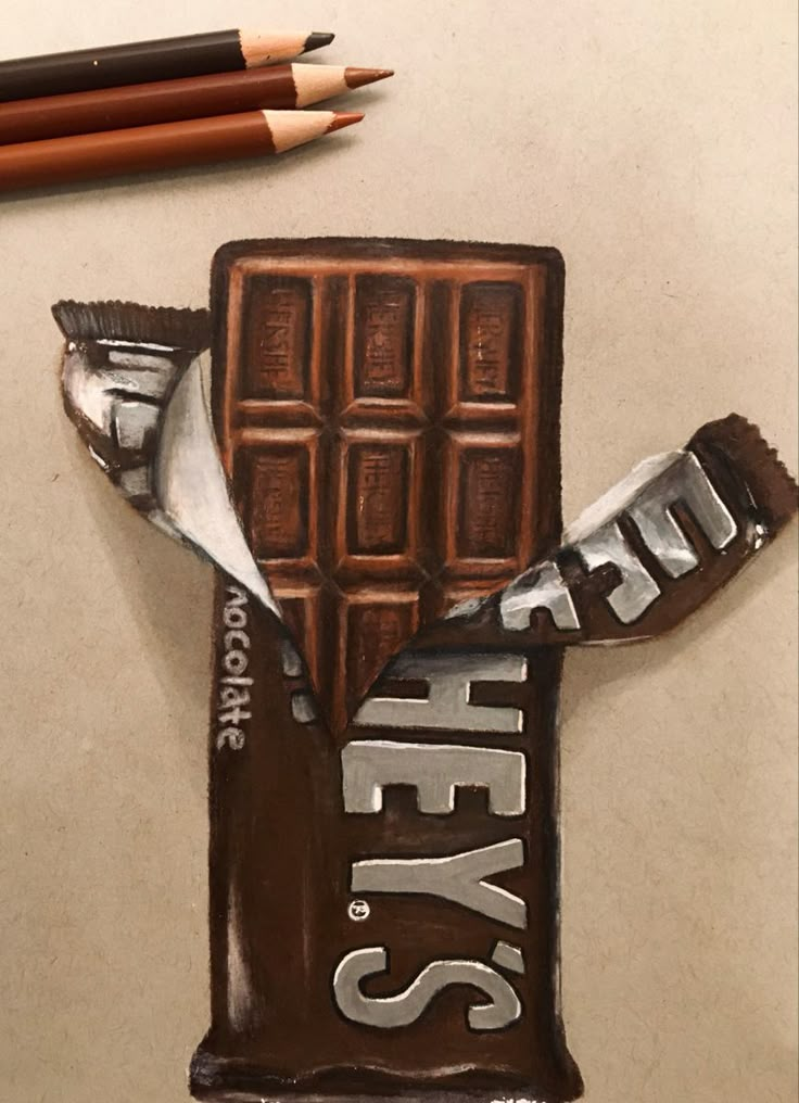 a chocolate bar with the word yes on it and some pencils next to it