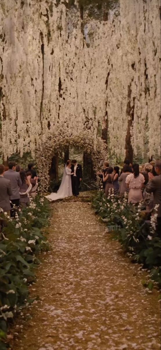 a bride and groom are walking down the aisle