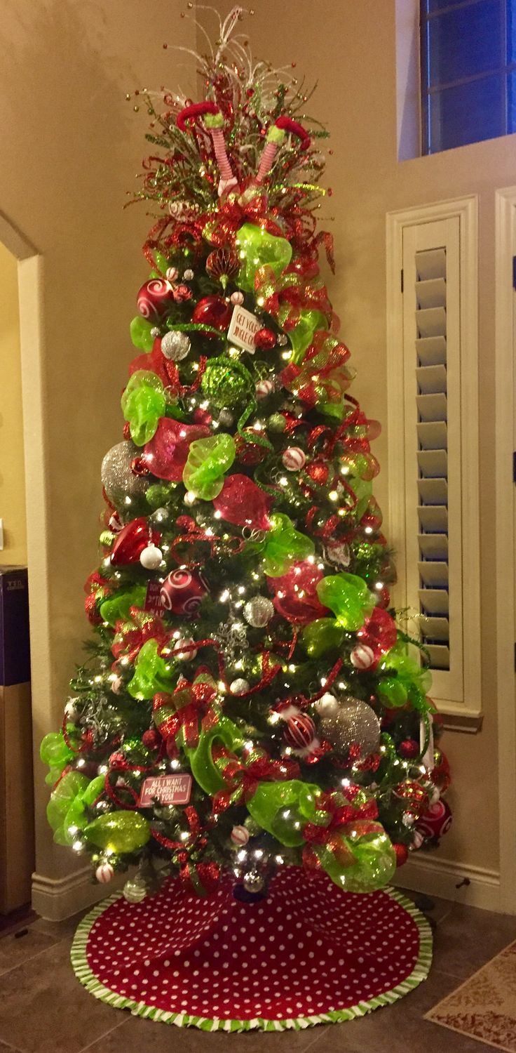 a christmas tree decorated with red, green and silver ornaments