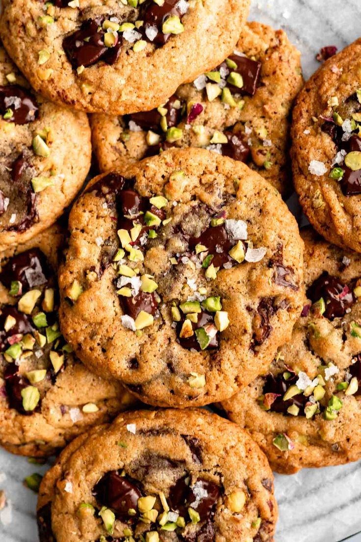 chocolate chip cookies with pistachios and almonds on a marble platter