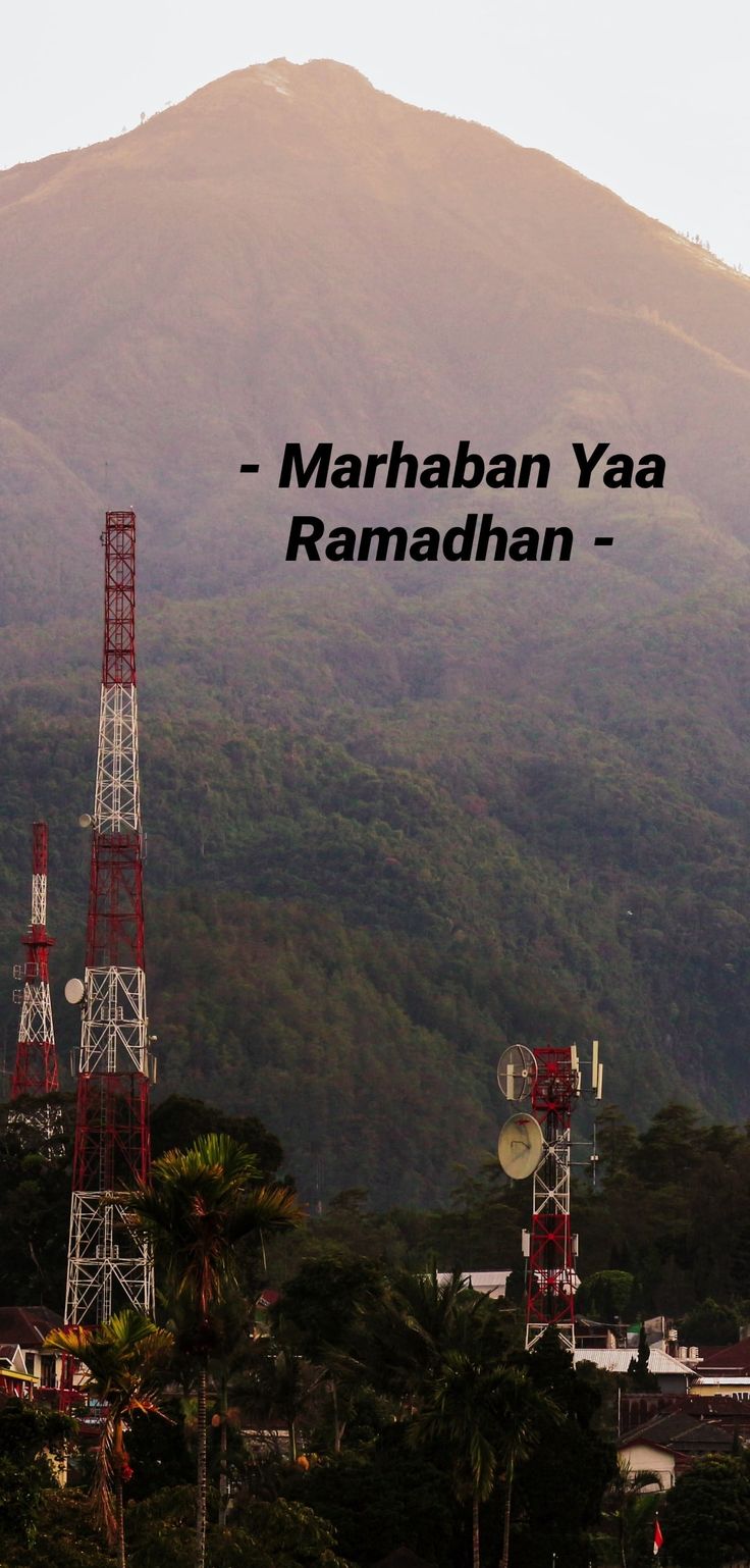 a radio tower in front of a mountain with the words marhabn yaa ramahan on it