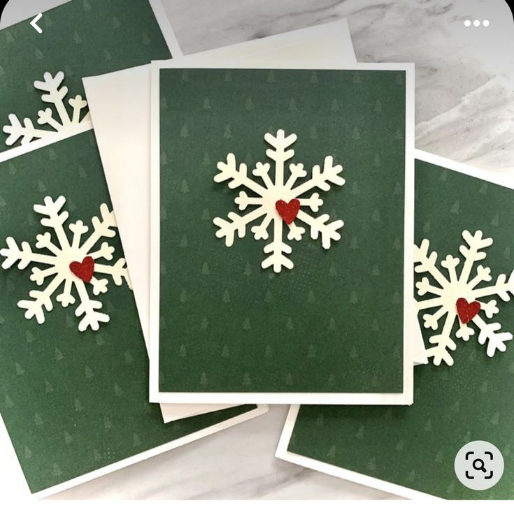 three cards with snowflakes on them, one is green and the other is white