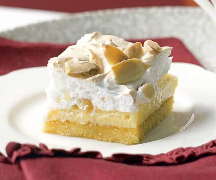 a piece of cake sitting on top of a white plate next to a red napkin