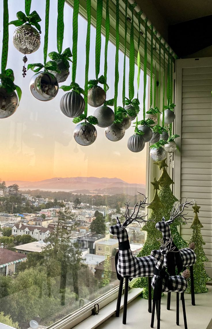 christmas decorations are hanging from the window sill