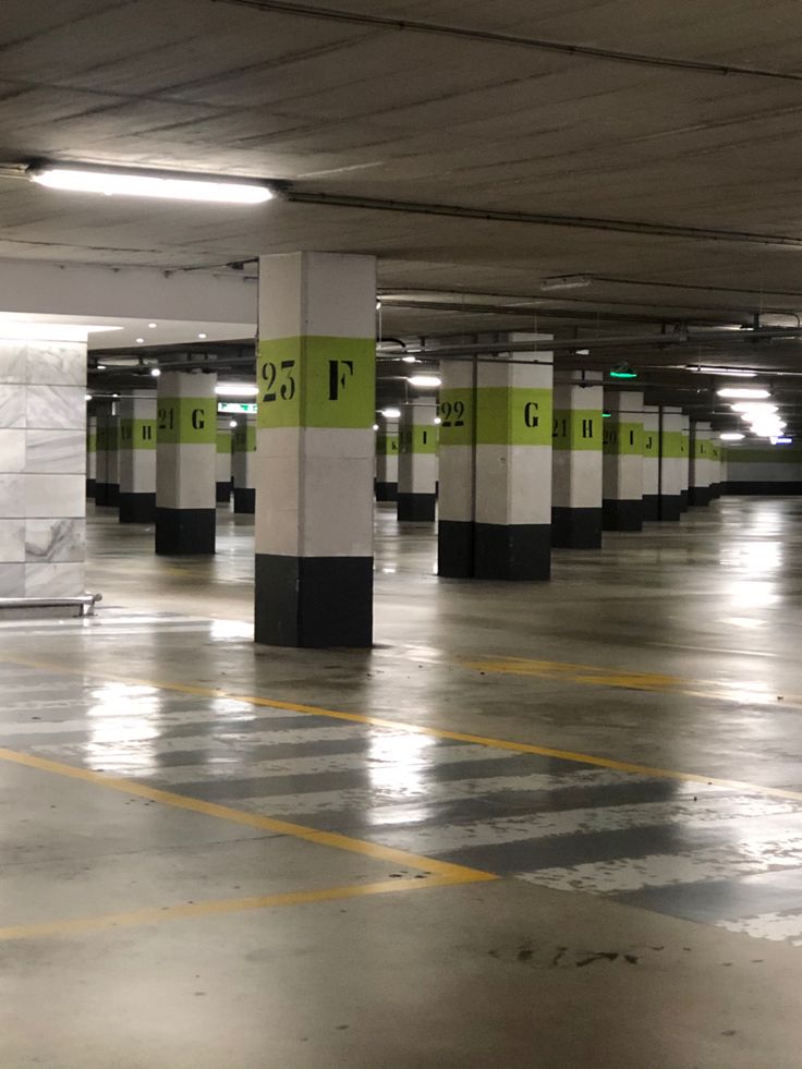 an empty parking garage with yellow and black stripes on the floor is pictured in this image