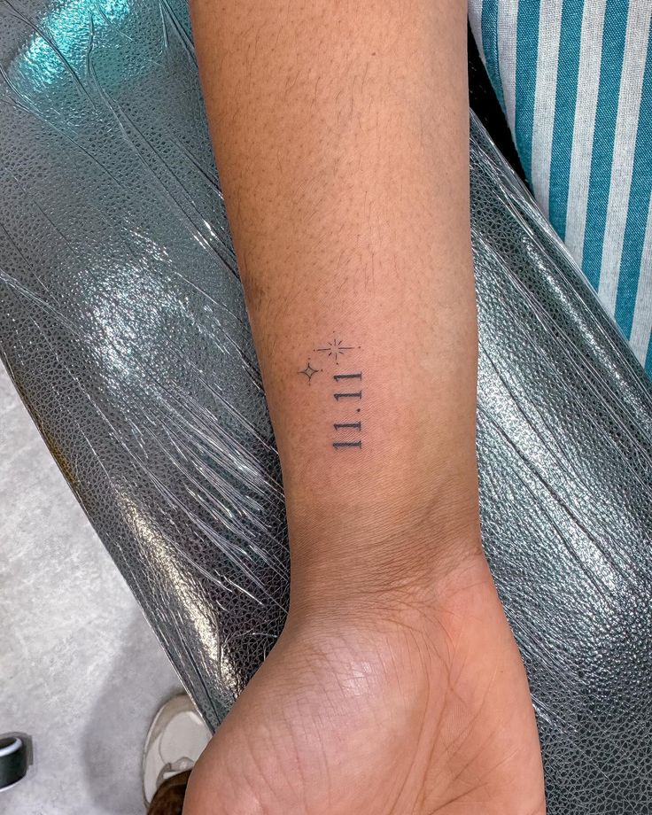 a person with a small tattoo on their left arm and the word life written in cursive letters