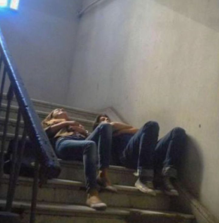 three people laying down on the stairs