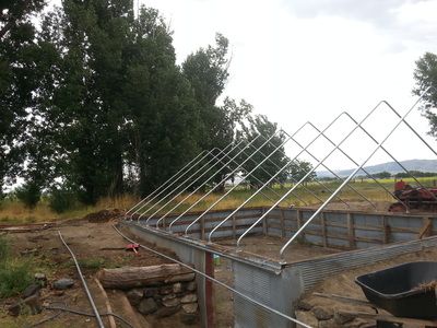 an old farm yard is being renovated with metal fencing