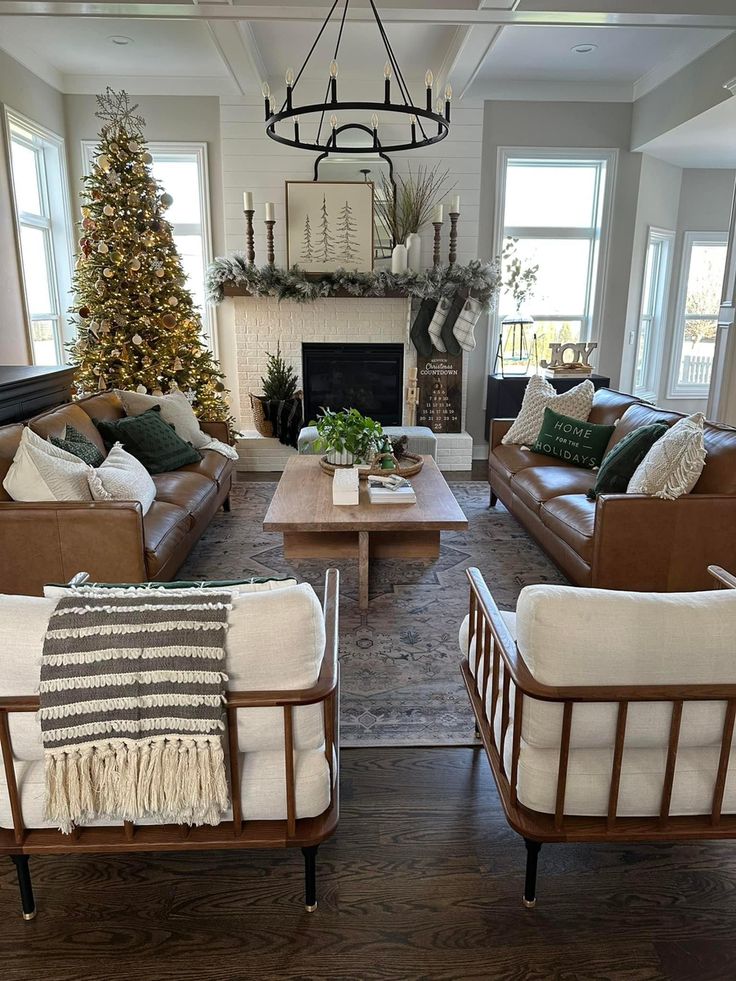 a living room filled with furniture and a christmas tree in the middle of the room