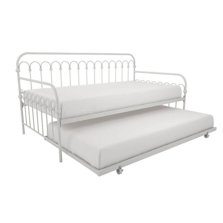 a white metal daybed with two mattresses