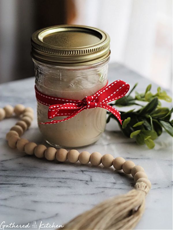 a jar filled with food sitting on top of a table next to a beaded necklace