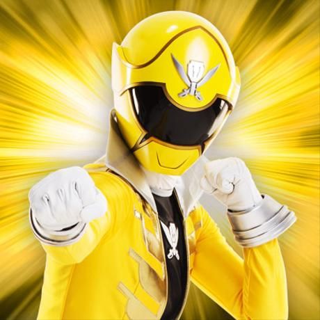 a man in a yellow power ranger costume with his fist up and one hand raised