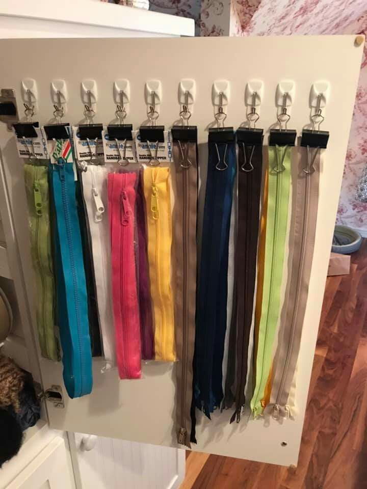 there are many different colored ties hanging on the wall