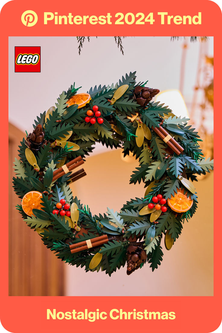 a christmas wreath hanging from the ceiling in front of a building with legos on it