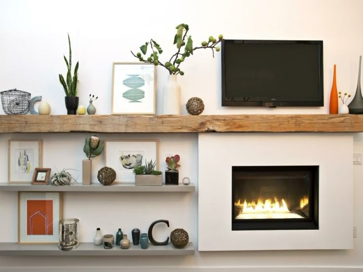 a living room with a fire place in the center and various decorations on the shelves