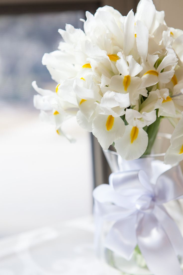 a vase filled with white flowers on top of a table