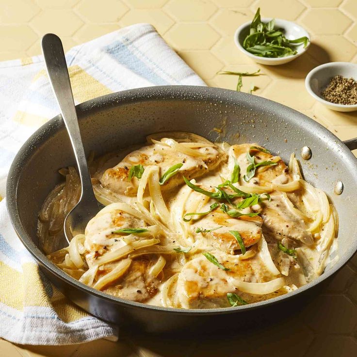 a pan filled with pasta and meat on top of a table