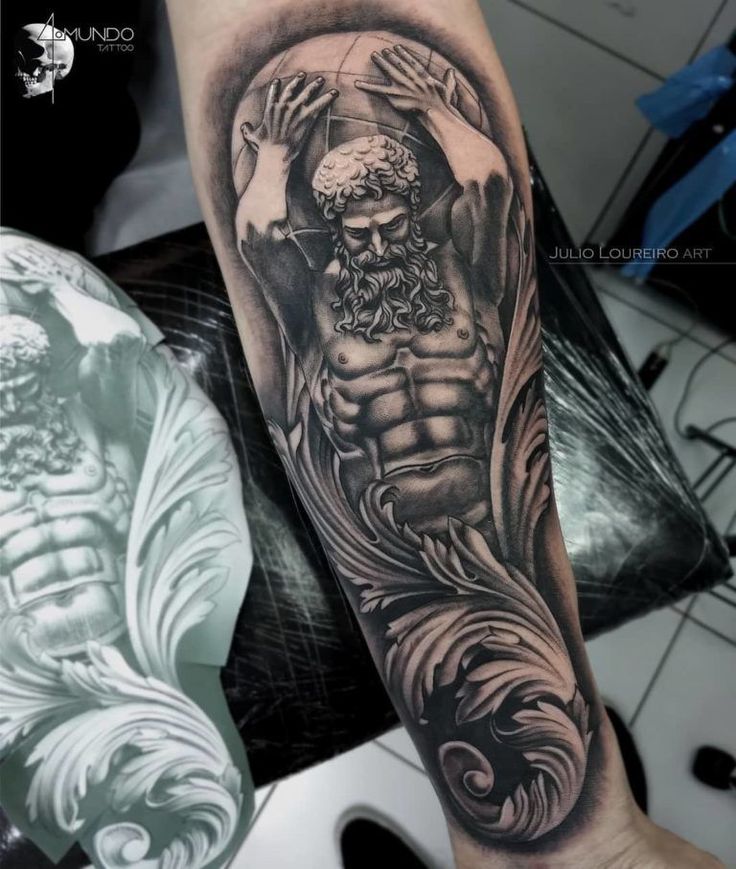 a man's arm with a black and white tattoo on it