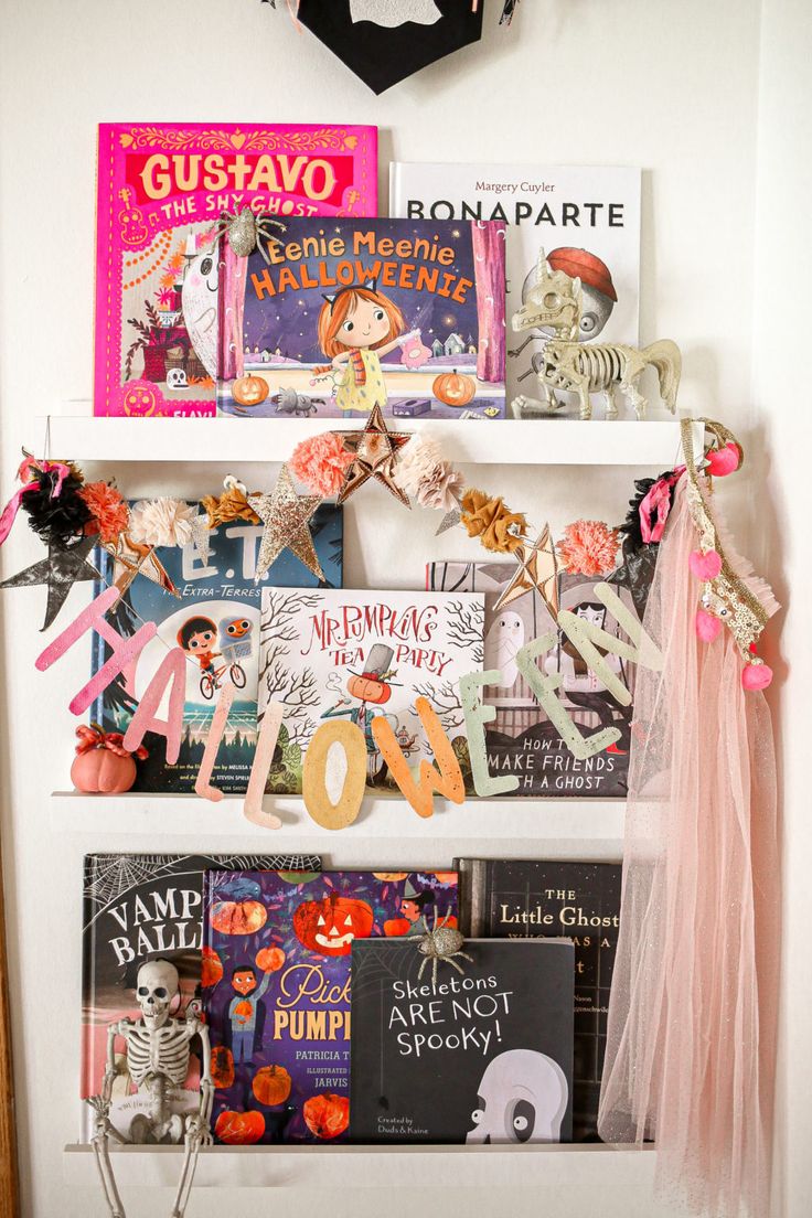 a book shelf filled with books and halloween decorations